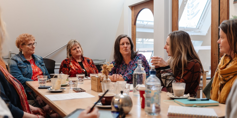 A group of people in a cafe sharing ideas.